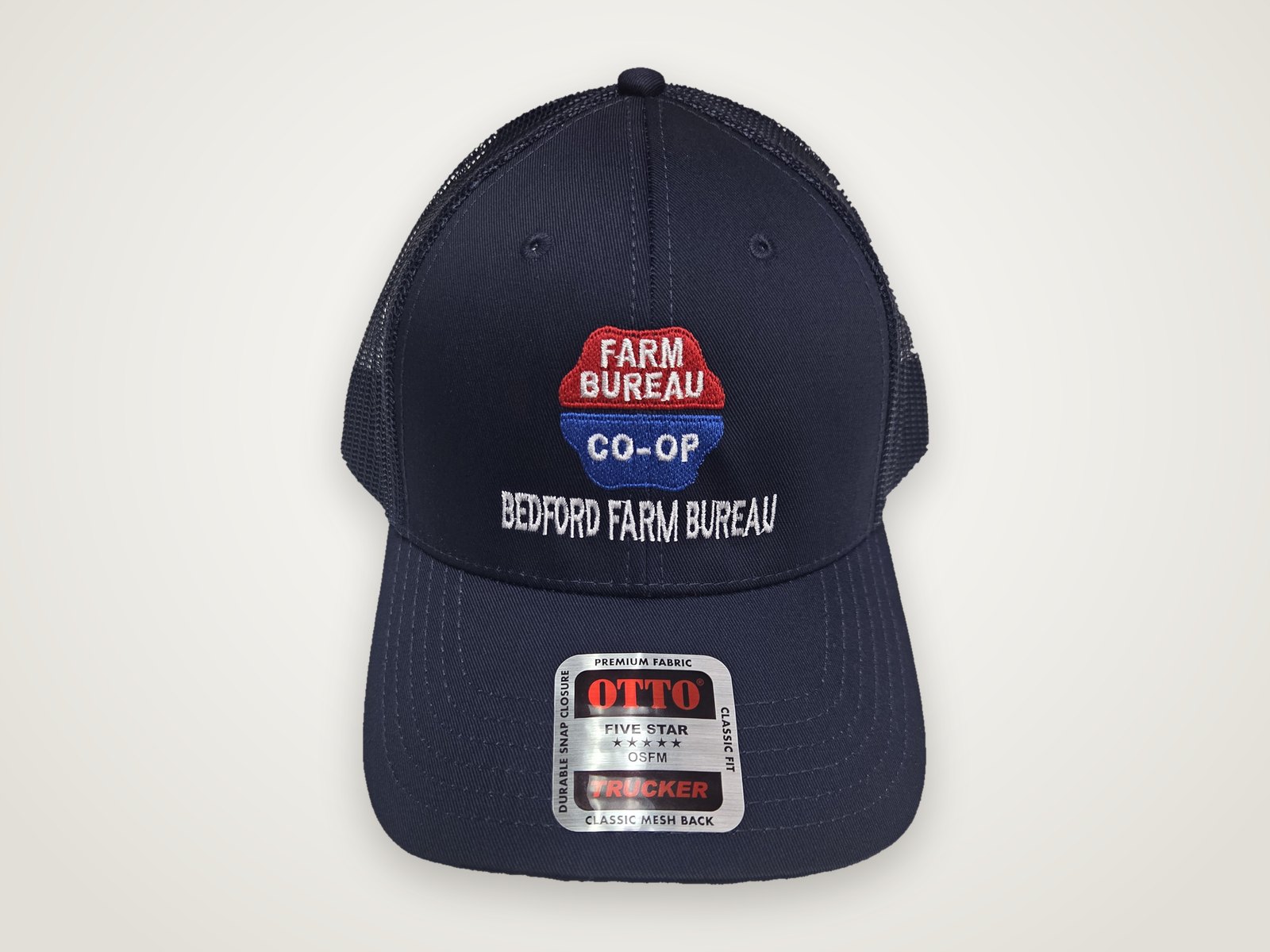 Navy trucker cap embroidered with the Farm Bureau Co-op logo and Bedford Farm Bureau text